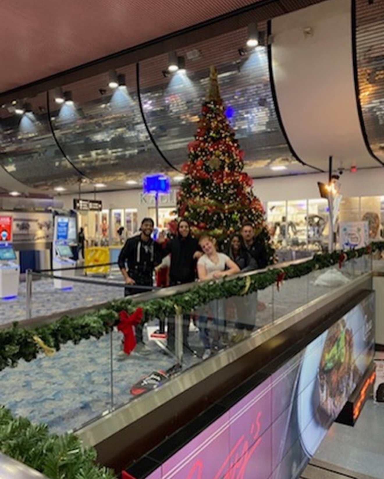 Crew installing a large Christmas tree