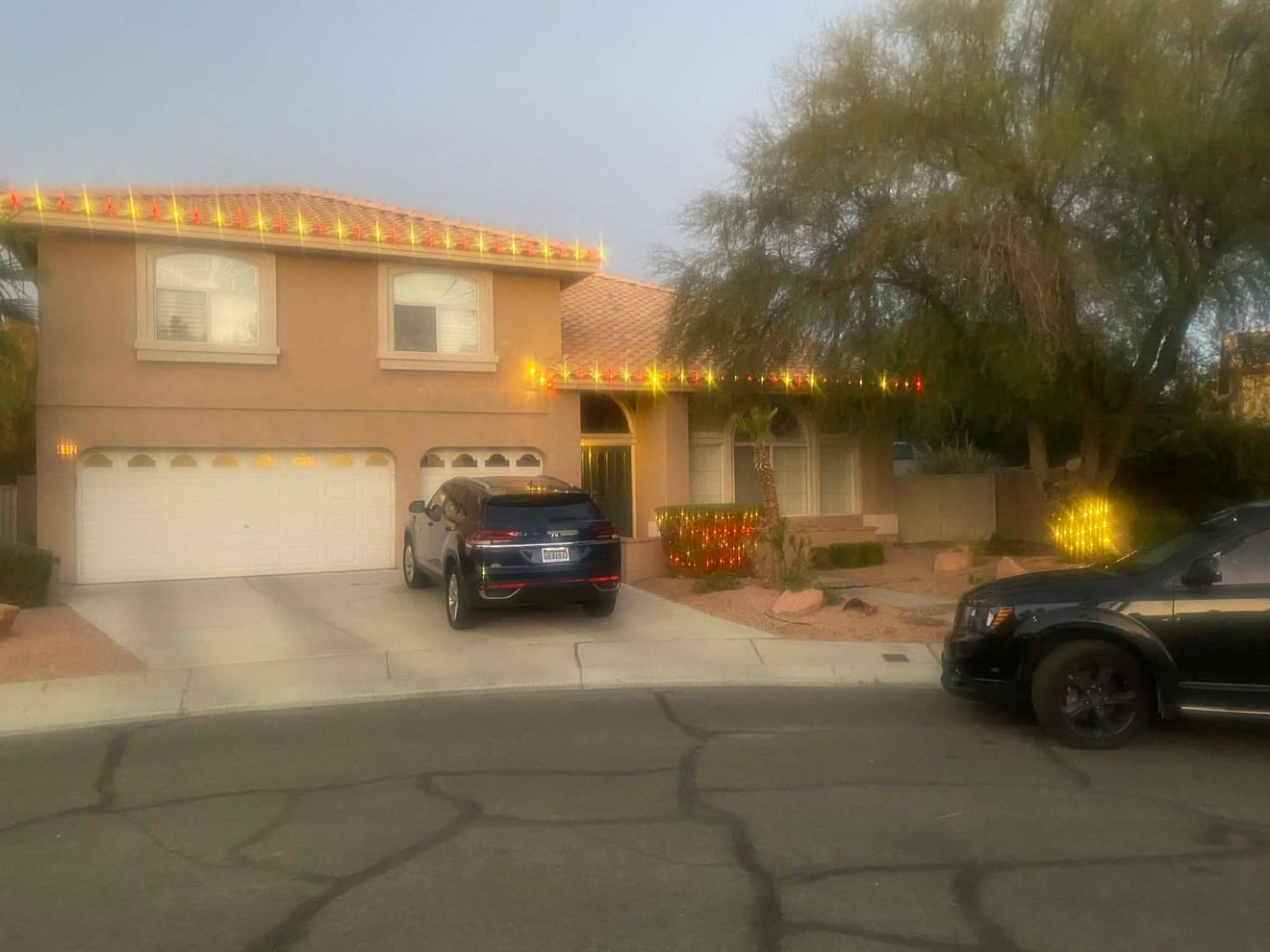 Two-story home dressed for the season at dusk